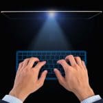 Hand of business on Digital virtual keyboard on black background