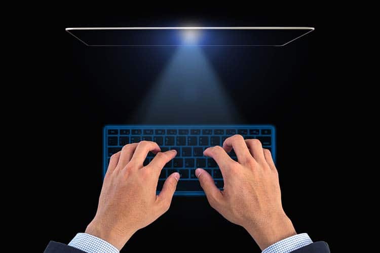 Hand of business on Digital virtual keyboard on black background