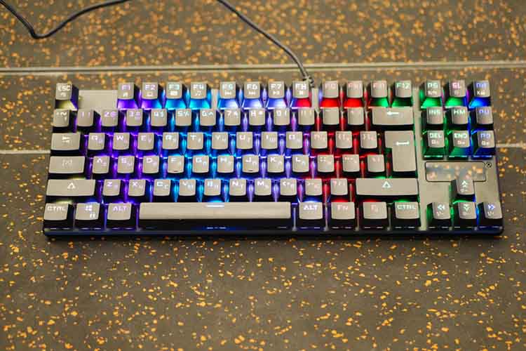 multi-colored keyboard. mechanical keys. Multi-colored professional gaming mechanical rgb keyboard on the table background